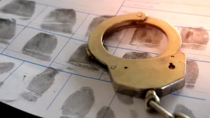 Handcuffs on top of fingerprints document