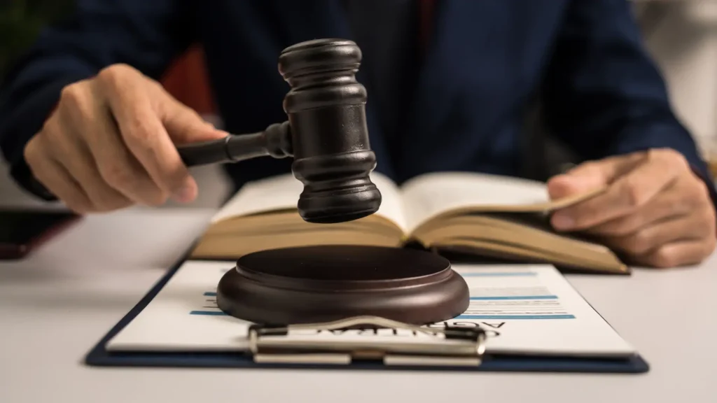 A judge holding a gavel over documents.